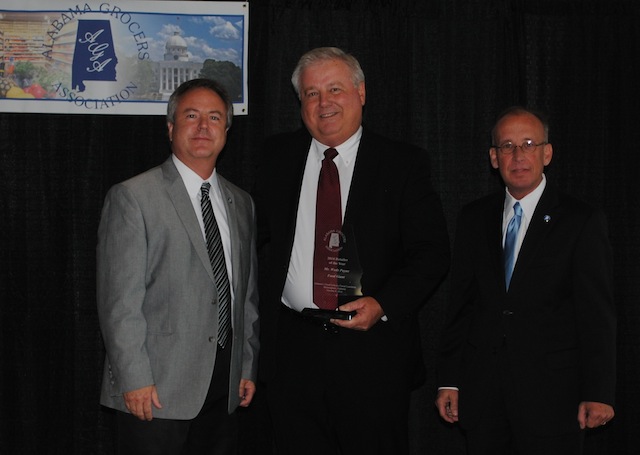 Harold Garrett, Gateway Foods and Johnny Fox, Moore's Marinades presents Wade Payne of Food Giant with the Retailer of the Year Award