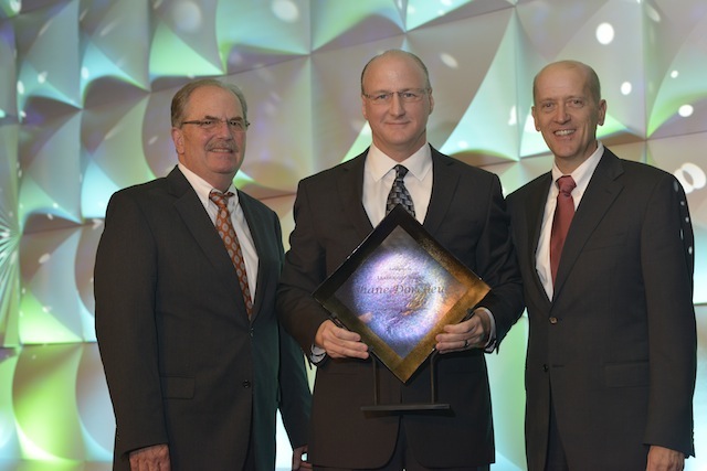 Retired Albertsons COO Bob Butler, left, and Albertsons-Safeway COO Wayne Denningham, right, presents Albertsons-Safeway Southwest Division President Shane Dorcheus with the AFMA Retailer of the Year Award.