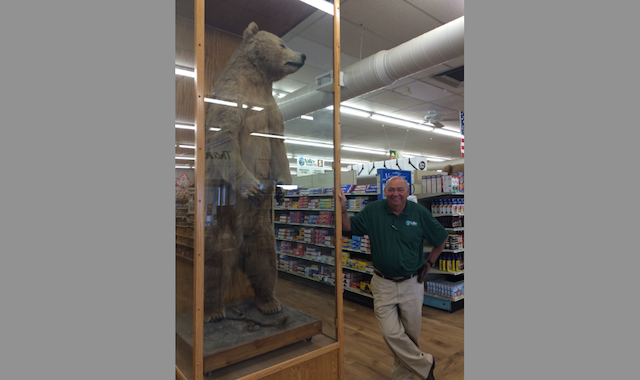 Valley Foods owner Tim Lamprecht has been in the food industry for 50 years. Here he stands next to one of the many mounts showcased within the store.