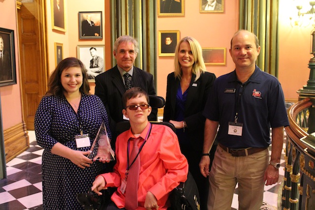 Allison Rouse Royster, managing partner, Rouses; Kyle Soignet, vocational director, Lafourche ARC; Jamie Tindle; Steve Galtier, director of human resources, Rouses; and, in front, Alex Tindle, Rouses' service clerk.