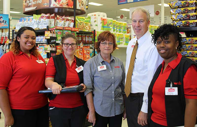 At the store located at 7200 Holabird Avenue in Dundalk are Brandi Hawkins, Katelynn Yingling, store manager Annette Gaydos, Weis SVP David Gose and Tonya Washington.