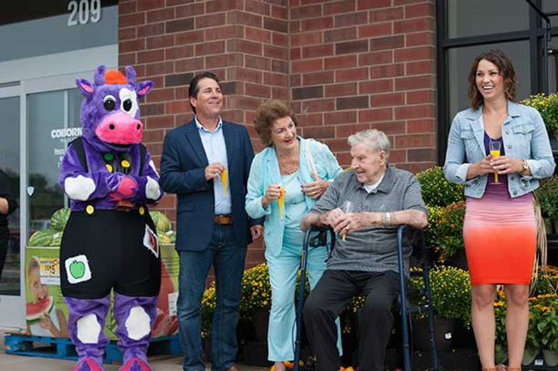 Coborn mascot Moo Bell with Chris, Mabel, Dan and Emily Coborn.