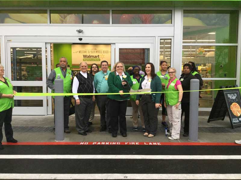 Store manager Sherrie Carlisle cuts the ceremonial ribbon on the new Walmart Neighborhood Market in Myrtle Beach.