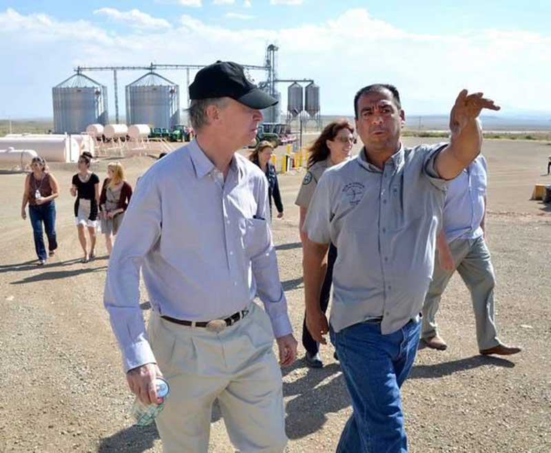 Colorado Gov. John Hickenlooper, left, is escorted by Simon Martinez, operations manager, Bow & Arrow.