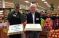 Store Director Jim Burns, right, congratulates employee Mike Mezzadri, who has worked for Shaw’s for 55 years.