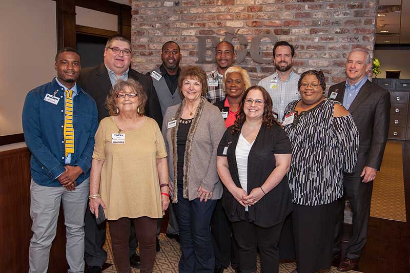 Brad Brookshire, chairman and CEO of Brookshire Grocery Co. (back row, far right), and Trent Brookshire, EVP of corporate development (back row, second from right), with the 2017 Jump Over the Counter honorees, from left: Ducien Allen, Chris Raabe, Totsy Gaar, Michael Nash, Connie Hendricks, Napoleon Brown, Jackie Grant, Candise Stone and Sherri Morgan.