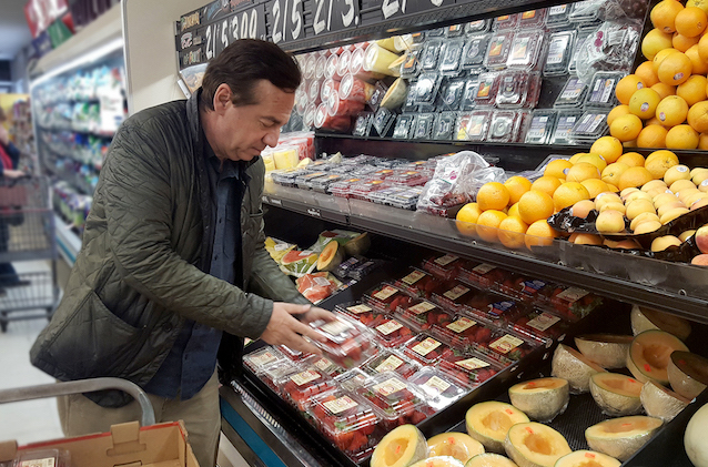 Peter Siakotos stocks strawberries.