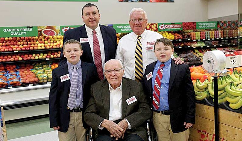 Grandsons J.P. Rowton, left, and William Rowton, right, flank their great-grandfather Oral Edwards; back, from left, Paul Rowton, company VP, with his father-in-law, company president Steve Edwards.