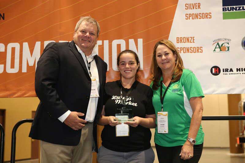 Kelina Salinas of Lucky's is Florida's best bagger. She's pictured with Florida Retail Federation President & CEO R. Scott Shalley and Florida Grocers Association Executive Director Josie Correa.