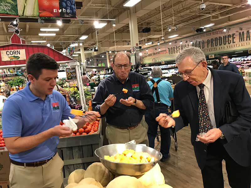 New Jersey Agriculture Secretary Douglas H. Fisher, center, samples Jersey Fresh cantaloupe at the ShopRite of Greater Morristown with Bob Sumas, right, president of Village Super Market Inc., and Tom Beaver, director of marketing and development for the New Jersey Department of Agriculture.  