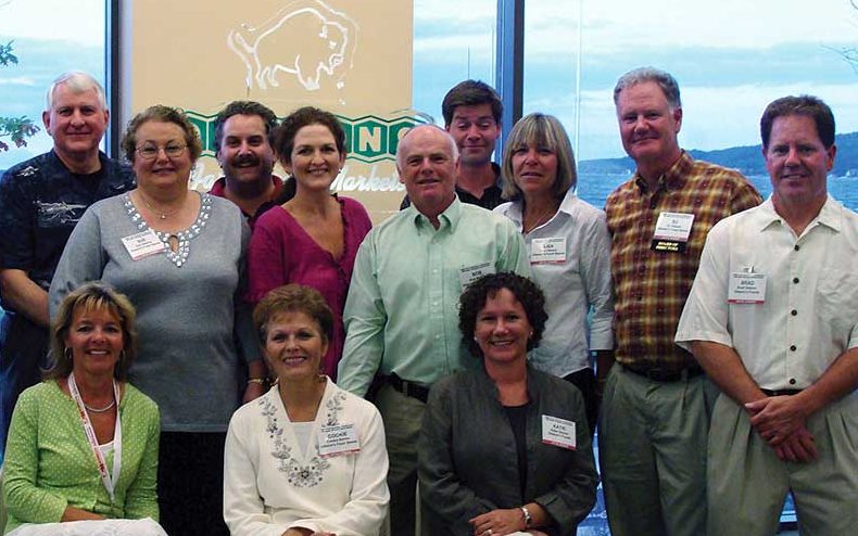 Oleson’s management team includes Marty Watts (front left), DJ Oleson and Brad Oleson (standing far right).