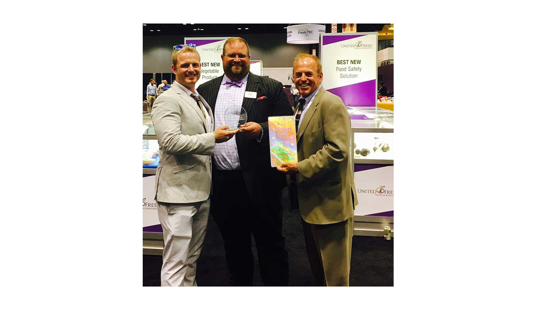 Food Freshness Card Inventors RJ Hassler and Rick Hassler accept the Innovation Award from John Toner (center), VP of United Fresh.