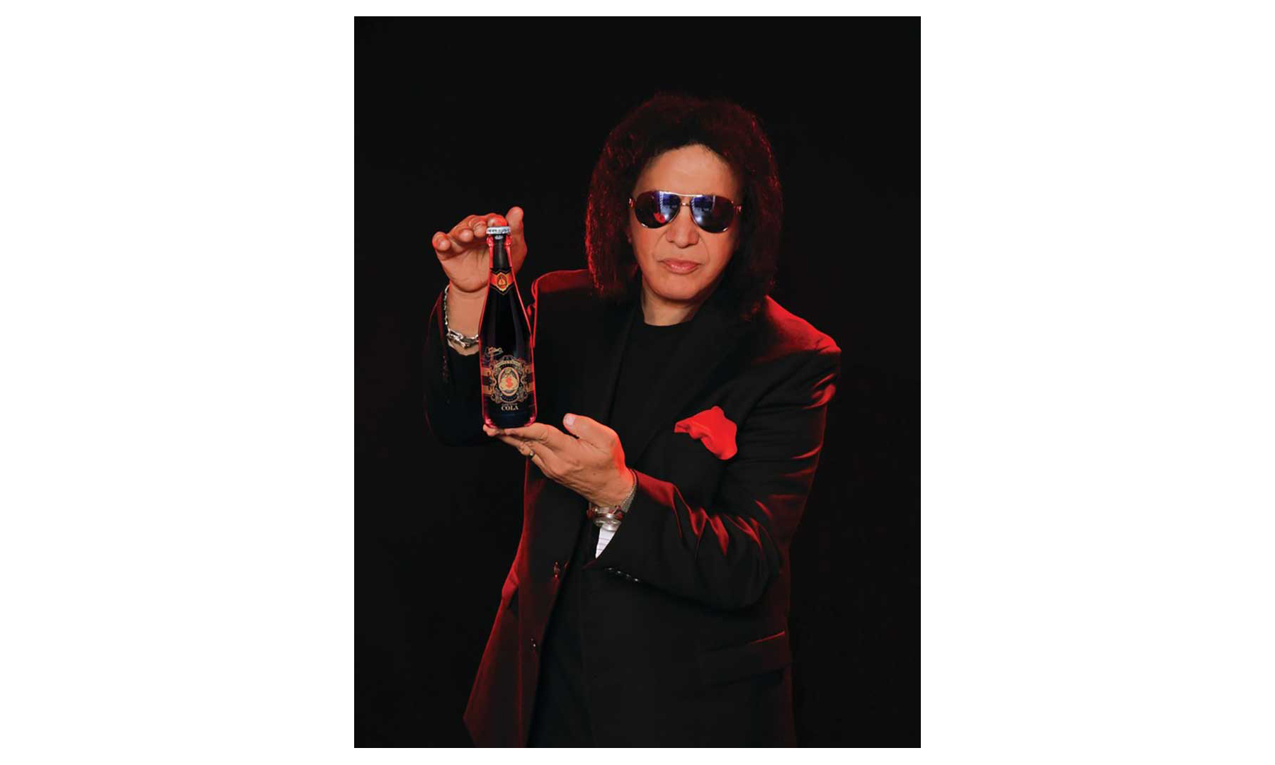 Gene Simmons holding a Money Bag soda bottle