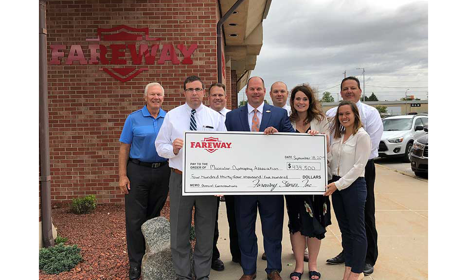 Fareway representatives present a check from the golf tournament.