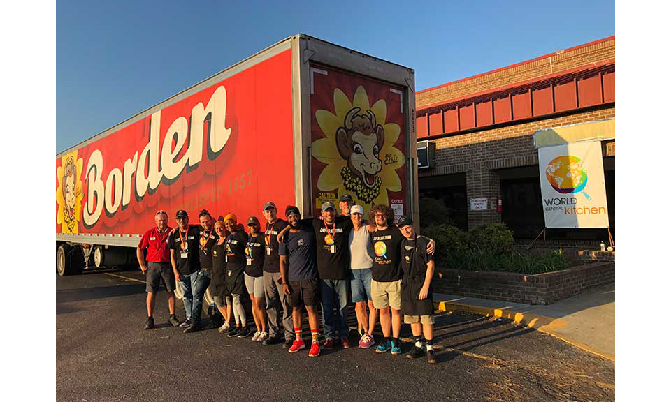 A group of people in front of a Borden truck