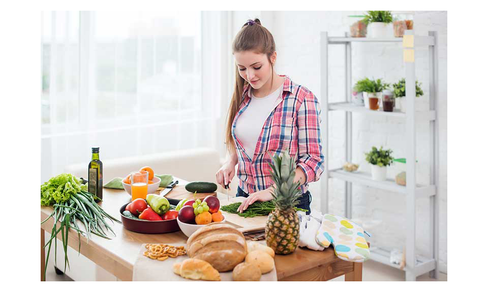 A young woman preparing dinner