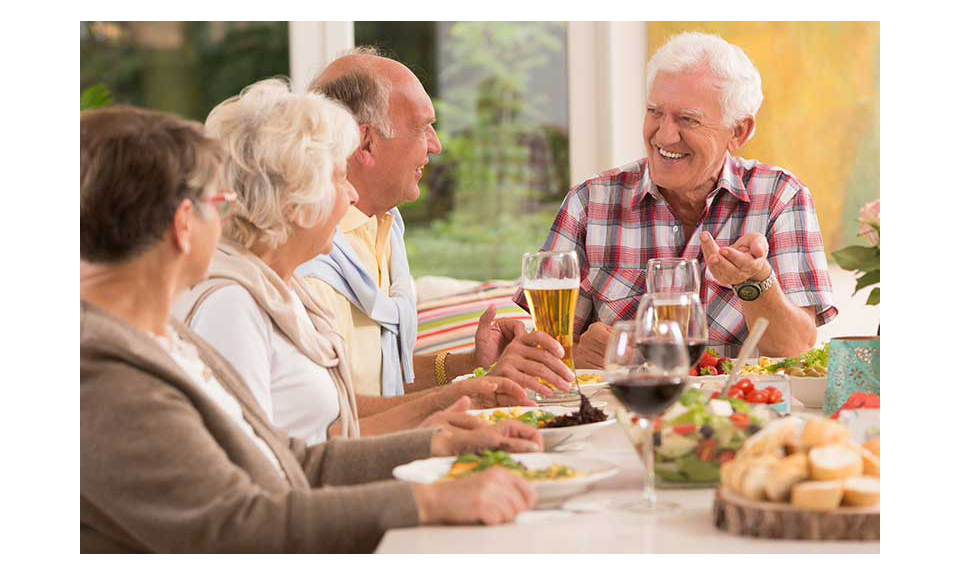 Aging consumers around a table eating.