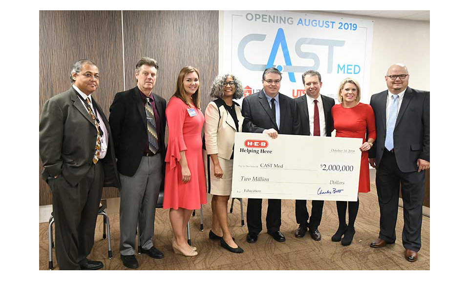 H-E-B representatives present a $2 million check for CAST Med High School.