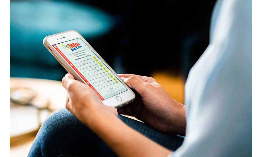 A woman holding a phone displaying lottery numbers