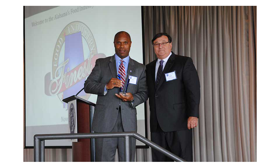 Curtis Lyons receives the vendor of the year award from Frank D'Amico III.