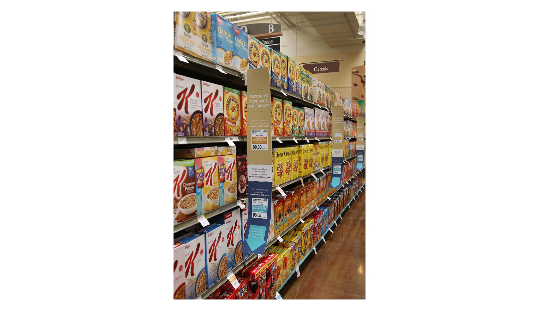 A Raley's cereal aisle with shelf blades explaining the new product placement.