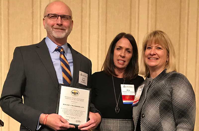 Sen. Roger Chamberlain, MGA Board Chairman Kris Kowalski Christiansen and MGA President Jamie Pfuhl.