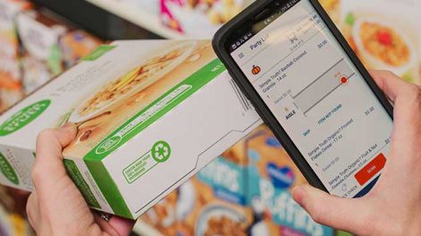 A woman scanning a cereal box with her smartphone