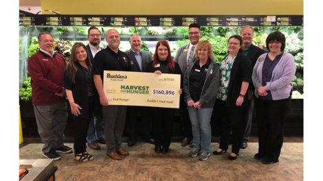 Buehler's Fresh Food employees holding Harvest for Hunger check