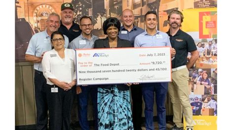 Representatives from The Food Depot and Albertsons Markets hold a check.