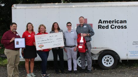 Hannaford representatives present a check to American Red Cross representatives for flood relief