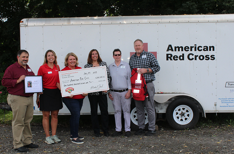 Hannaford representatives present a check to American Red Cross representatives for flood relief