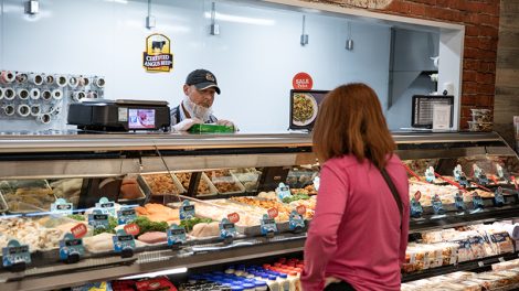 Food City employee helps a customer at the meat counter