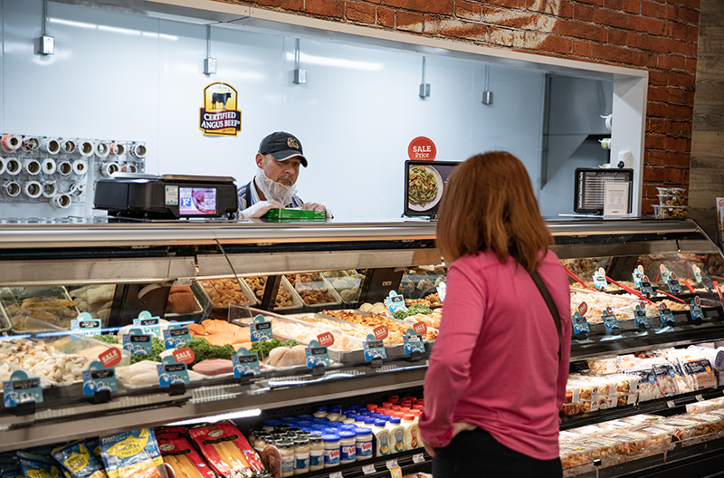 Food City employee helps a customer at the meat counter