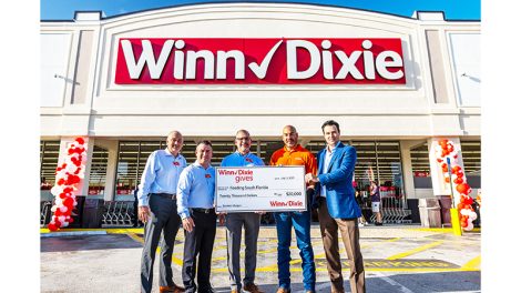 Southeastern Grocers representatives present a donation check to Feeding South Florida to fight hunger.