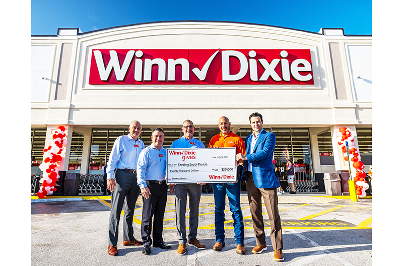 Southeastern Grocers representatives present a donation check to Feeding South Florida to fight hunger.