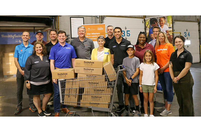 Representatives from Smithfield Foods and Kroger join together to donate 30,000 pounds of protein to Gleaners Food Bank of Indianapolis.