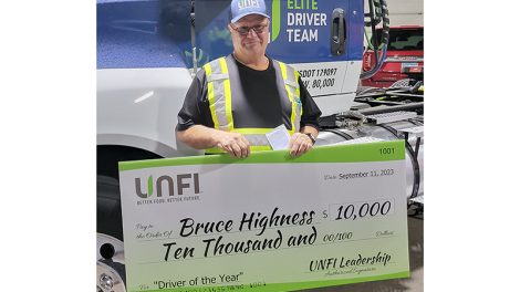 Bruce Highness receiving his new truck and check from UNFI