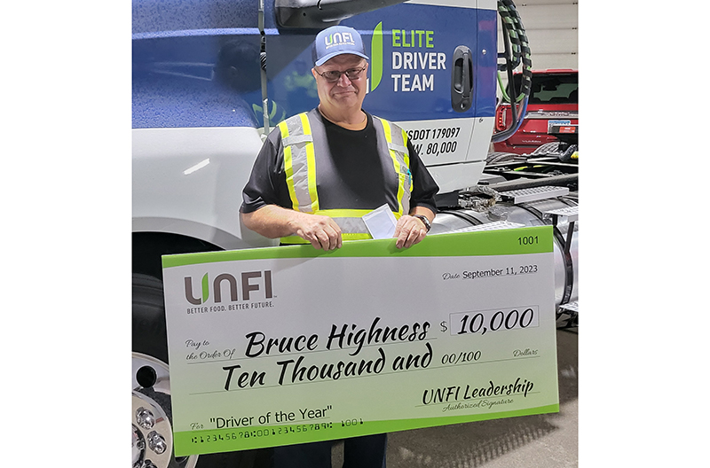 Bruce Highness receiving his new truck and check from UNFI