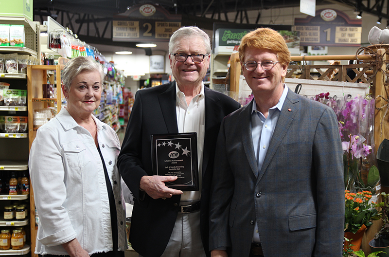 Foothills IGA accepting the Spirit of IGA award from John Ross, president and CEO.