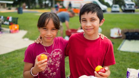 Two children eating food provided through Albertsons Cos. Foundation donation