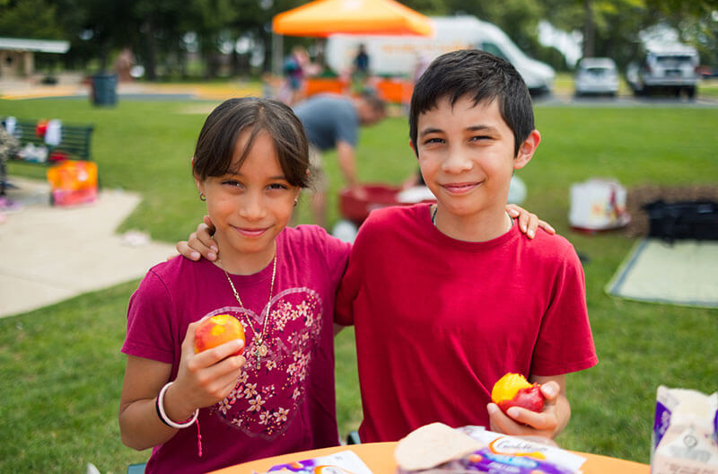 Two children eating food provided through Albertsons Cos. Foundation donation