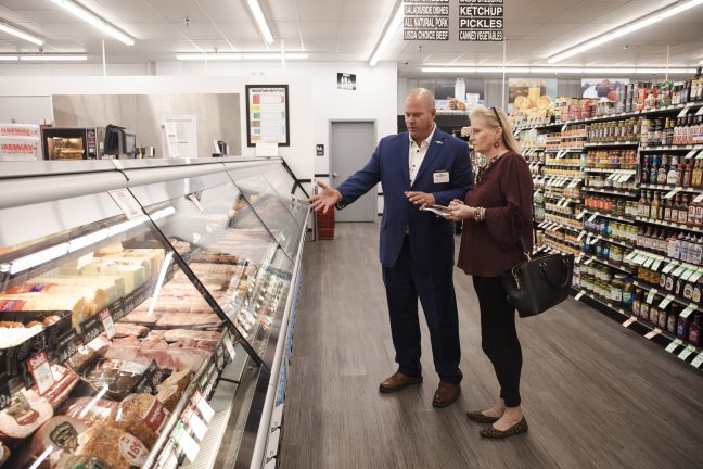 Fareway CEO Reynolds Cramer takes Shelby Publishing President Stephanie Reid on an in-store tour. 