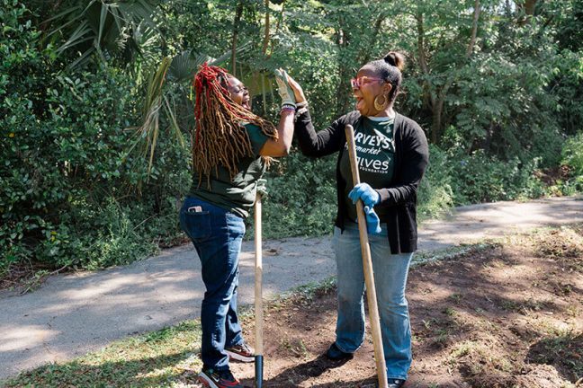 SEG Harveys Supermarket associates high-five during clean up effort