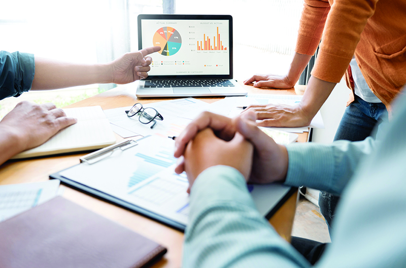 business people surrounding a computer during a meeting