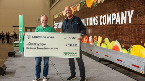 SpartanNash CEO Tony Sarsam presenting check to representative of Convoy of Hope