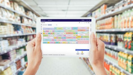 tablet using dunnhumby assortment AI in store aisle