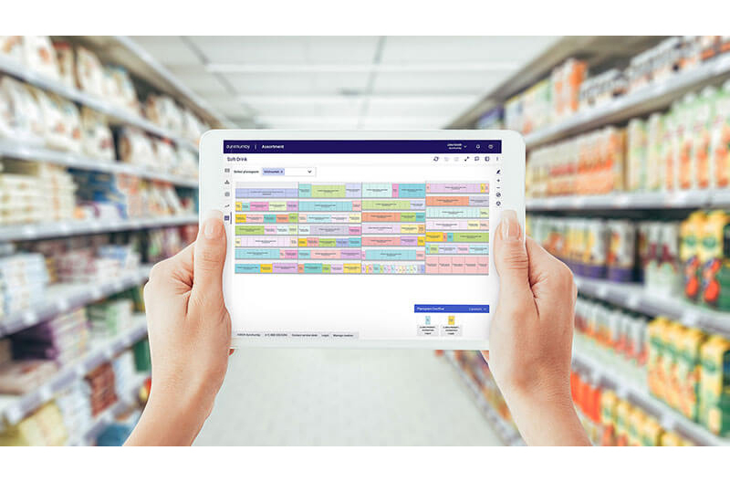 tablet using dunnhumby assortment AI in store aisle