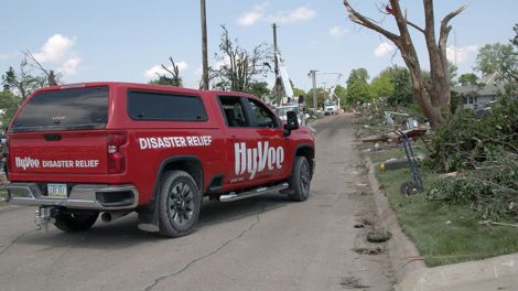 image of Hy-Vee disaster relief pickup truck in storm damaged neighborhood