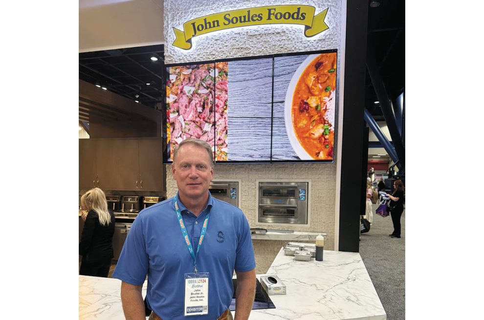 image of John Soules standing in front of John Soules Foods booth