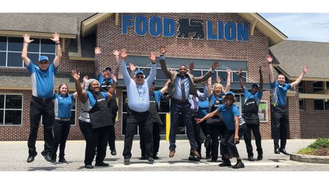 image of group of Food Lion associates jumping in front of store